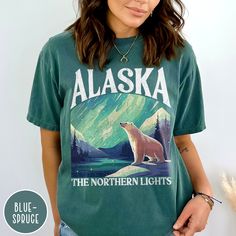 "Celebrate the beauty of Alaska and its beautiful Northern Lights also known as the Aurora Borealis with our custom designed Alaska Shirt. This crewneck celebrates nature's most amazing light show while also featuring the North American Polar Bear staring up at the beautiful starry display. Perfect for an Alaska family vacation or an Inner Passage Alaska Cruise, this sweatshirt comes in all sizes big and small for oversize and regular fits. So grab one today and celebrate the wonder of the Alaskan Frontier and the awe inspiring Northern Lights in style! PLEASE NOTE This is a standard unisex size Comfort Colors Tee. For an oversized tee, please size up. If you are looking for an oversized \"T-shirt Dress\" look, we recommend sizing up 2 sizes. Please review the size chart to ensure you rece Alaska Family Vacation, Aurora Borealis Alaska, Alaska Trip, Alaska Vacation, Oversized T Shirt Dress, Cruise Shirt, Alaska Cruise, Bear Shirt, Dye Shirt