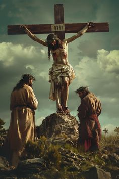 jesus on the cross with three people standing around him and looking at it from above