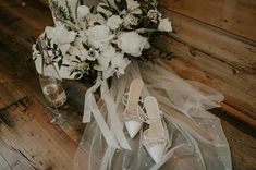 wedding bouquet and shoes sitting on the floor