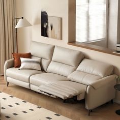 a living room with a white couch and pillows