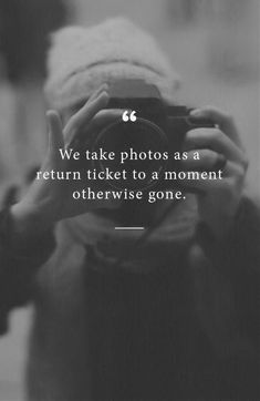 a person taking a photo with a camera in front of a black and white background