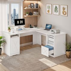 a white desk with a computer on it in a room next to a large window