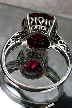 "Garnet CZ Ring K Ring Design#4 Custom Made This is a brand new Victorian design in solid sterling silver. The beautiful trellis filigree of the ring is amazing vintage style. This full cut sparkling CZ gemstone is 12mm ( approximately 1/2\") in diameter. The inside of the band is marked 925 for sterling silver. It is a ring that will be treasured as an heirloom. Notice the beautifully intricate design of the silver filigree setting and trellis band. This alluring ring has beautiful shine and lu Classic Silver Ruby Ring For Valentine's Day, Garnet Rings With Intricate Design, Fine Jewelry Red Ruby Ring With Intricate Design, Red Oval Filigree Ring With Intricate Design, Silver Ruby Rings For Collectors, Red Ruby Ring With Intricate Design, Garnet Ruby Ring With Intricate Design As Gift, Garnet Rings With Intricate Design For Gift, Collectible Silver Garnet Jewelry