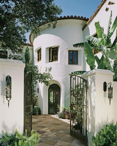 a white house with an iron gate in front