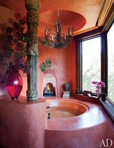 a bath room with a large tub and a chandelier