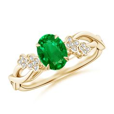 an oval emerald and diamond ring in yellow gold