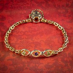 A beautiful Antique Edwardian bracelet from the early 20th Century made up of articulated 9ct Gold links which lead to a lovely open-worked gallery dotted with two Peridots and an Amethyst.  The piece is held by a 9ct heart padlock and safety chain complete with the maker's initials on the back. It's in excellent condition and would make a perfect gift for a loved one.  WEIGHT: 9 grams   MEASURES: Length 7.5 inches x Width 8mm across the gallery, 3.5mm across each link. Padlock: Height 19mm x Wi Edwardian Bracelet, Chic Rings, Heart Padlocks, Gold Link Bracelet, Antique Bracelets, Lock Style, Safety Chain, Twist Ring, Antique Shops