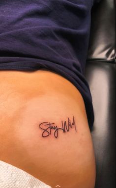 a woman's stomach with the word stay wild written in cursive writing