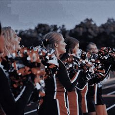 the cheerleaders are lined up and ready to perform