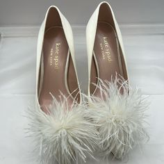 Disclaimer Below Kate Spade New York Marabou Heel Is Your Ticket To The Glamorous Nightlife Of The Vogue City. Allover Glitter Textile Upper. Soft Leather Lining And Insole. Slip-On Style. A Puff Of Delicate Feathers Adorns The Upper. Point Toe Construction. Stiletto Heels. Leather Outsole. Color: Ivory There’s A Stain On The Left Shoe, Green Stain Probably Can Be Clean. Please Look At Pictures Closely!!! Other Than That No Sign Of Use Except Being Tried On. Chic White Kate Spade Heels, Kate Spade White Round Toe Heels, Kate Spade White Heels For Spring, Feathered Heels With Round Toe, Kate Spade Shoes, Color Ivory, Kate Spade New York, Women's Pumps, Night Life