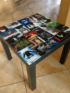 a table that has been made out of magazines on the top, and is sitting in front of a tiled floor