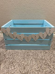 a blue crate with hearts on it sitting on the floor