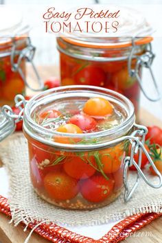 tomatoes and other vegetables in jars on a cutting board with text overlay that reads easy pickled tomatoes