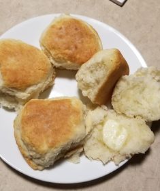 some biscuits and butter on a white plate