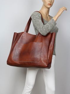 "Sturdy high quality genuine Italian leather bag.  Bag is very roomy and comfortable. Can be used as daily bag, shopper, travel, school bag.. Minimalist soft leather oversized shoulder bag. This bag comes in full grain leather and features an oversized, slouchy silhouette, relaxed top handles. Inside there is a large zipped pocket. 100% handmade, made only of genuine leather, you can use it for every day and it will reliably serve you for many years! Height: 39 cm / 15.4\" Max width at the top: 61 cm / 24\" Width at the base: 51 cm / 20\" Depth: 10 cm / 4\" Handle drop: 26 cm / 10\" MORE COLORS: COGNAC BROWN : https://www.etsy.com/listing/825369157/cognac-brown-large-handbag-made-of-thick?click_key=6162f46abe06691effc0e0c0444640745725769e%3A825369157&click_sum=1ed5d880&ref=shop_home_active Cognac Leather Bag, Extra Large Tote Bags, Excess Baggage, Soft Leather Tote, Slouchy Tote, Leather Tote Bag Women, Cowhide Bag, Large Handbag, Italian Leather Bags