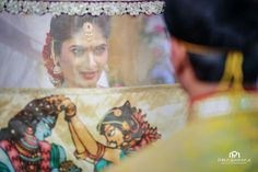 a close up of a woman looking at a painting on the back of a vehicle