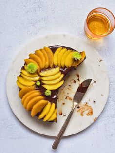 there is a piece of cake with fruit on it and a spoon next to it