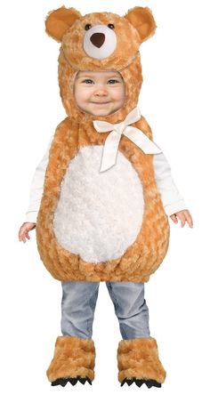 a little boy dressed in a teddy bear costume