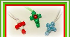 three different colored beads are hanging from a string on a white surface with green and red border