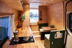 the interior of a tiny house with wood paneling and green accents on the walls