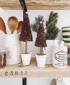 pine cones and spoons are sitting on the shelves in this kitchen, along with other christmas decorations