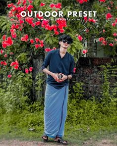 a man standing in front of a tree with red flowers on it and the words outdoor preset above him