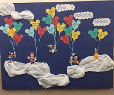 a bulletin board decorated with mickey mouse balloons