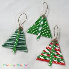 three small christmas trees made out of popsicle sticks are hanging from twine string