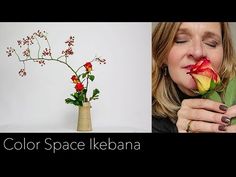 a woman holding a flower in front of her face and the words color space kebana