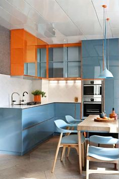 a modern kitchen with blue and orange cabinets