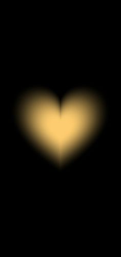 a heart shaped object in the dark with yellow light coming from it's center