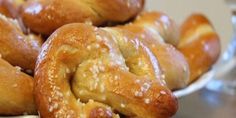 a white bowl filled with croissants on top of a table