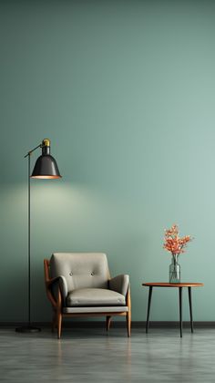 an empty room with a chair, table and lamp on the floor next to it