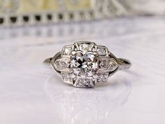 an antique diamond ring sits on a table