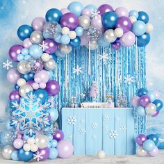 a birthday party with balloons, streamers and snowflakes