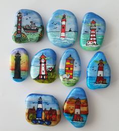 six painted rocks with lighthouses on them