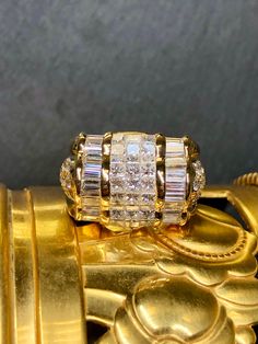 A stunning cocktail ring of very generous proportions. Crafted in supple 18K yellow gold, this ring is channel, bead and invisibly set with baguette princess and round cut diamonds and they are all dazzling! Stones range G-I in color and Vs1+ clarity and come to approximately 5.90cttw. Dimensions/Weight: Ring measures .75” top to bottom and .75” wide and weighs 17g. Size 7 (sizable). Condition: All stones are secure and in perfectly wearable condition. R-HAN The Witcher Geralt, Princess Diamond, Diamond Cluster, Cluster Ring, Cocktail Ring, Round Cut Diamond, Cocktail Rings, Jewelry Rings, Yellow Gold