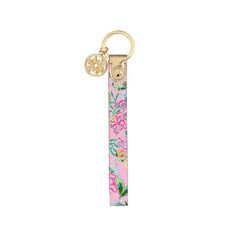 a pink keychain with flowers and leaves on it