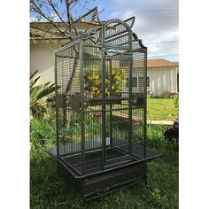 a black bird cage with yellow flowers in it