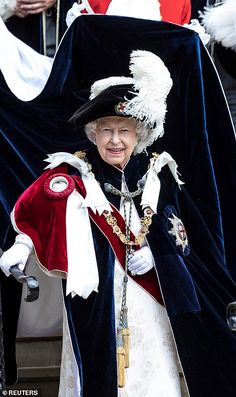 an old woman dressed in costume standing next to other people