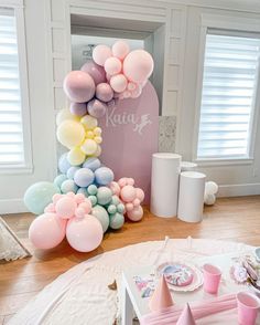 a table with balloons and plates on it