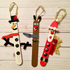 three popsicle puppets made to look like santa, snowman and rudolph the reindeer