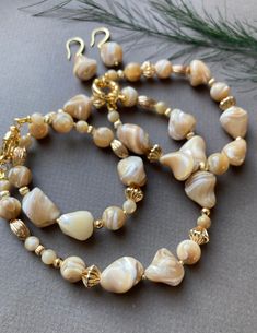 Zonerse feminine beautiful jewelry set of Natural Trochus Shell beads. This set can be worn in many ways such as festive and special occasions. This necklace can also be combined with casual outfits, for a touch of extra charm. Bracelet and earrings match very well with the necklace. ☀️Stone: Natural Trochus Shell Irregular Beads 7 -16mm and 8mm ☀️The length is approximately 52 cm (incl. clasp) ☀️Details and closure are gold plated ☀️Bracelet is 17 cm I accept custom orders for jewelry: earrings Pearl Jewelry Set, Mother Of Pearl Jewelry, Gold Plated Bracelet, Necklace Stone, Pearl Jewelry Sets, Felted Scarves, Set Necklace, Gold Plated Bracelets, Shell Beads