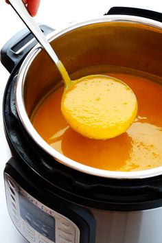 a ladle scooping some soup out of an instant pot