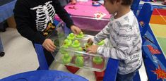 two young boys are playing with plastic toys