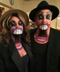 two people with painted faces posing for the camera