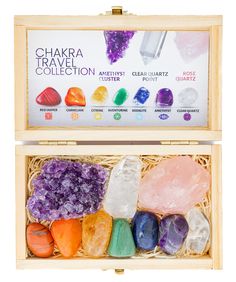 the chakra travel collection in its wooden box is filled with colorful rocks and crystals