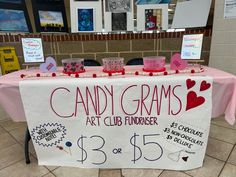 a table that has some candy on top of it with writing and pictures around the table