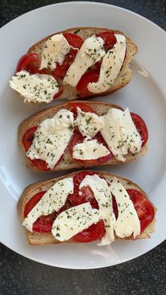 three pieces of bread with cheese and tomatoes on them