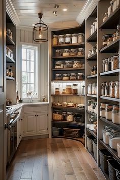 a kitchen with lots of shelves filled with food and cooking utensils in it